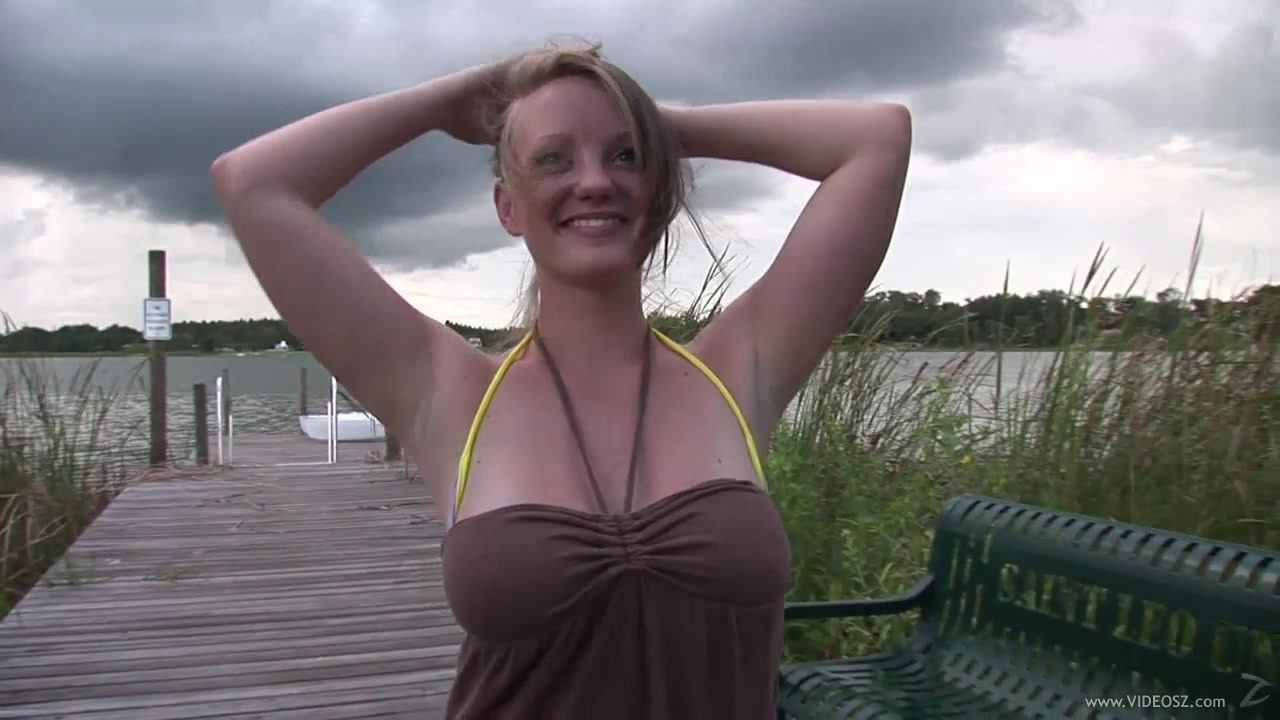 A gorgeous girl shows and fondles her big boobs in a park